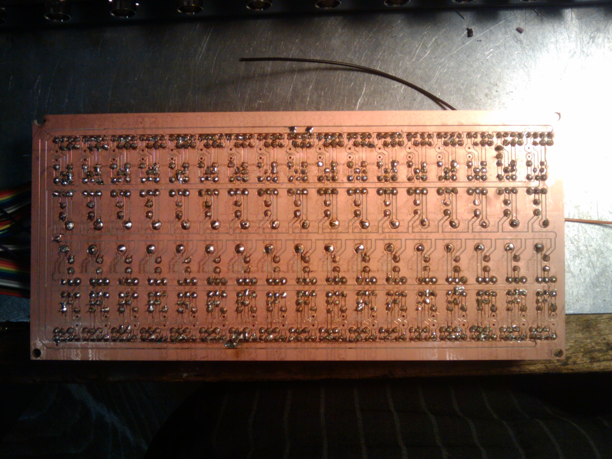 Reverse side of custom etched output stage circuit board. Opto-couplers and more provide an output stage for the ATMega1280. 